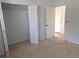 Bedroom with carpeted floor, a closet and neutral walls providing a serene atmosphere at 11282 Sw 62Nd Avenue Rd, Ocala, FL 34476