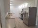 Updated kitchen featuring new stainless steel appliances, white cabinetry and vinyl flooring at 11282 Sw 62Nd Avenue Rd, Ocala, FL 34476