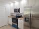 Bright kitchen features stainless steel appliances, granite countertops, and white cabinets at 11282 Sw 62Nd Avenue Rd, Ocala, FL 34476