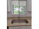 Stainless steel sink set in granite countertops in kitchen with a window view at 11282 Sw 62Nd Avenue Rd, Ocala, FL 34476