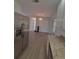 The living room area featuring vinyl plank flooring and neutral paint at 11282 Sw 62Nd Avenue Rd, Ocala, FL 34476