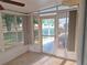 Enclosed porch boasts an outdoor ceiling fan and tile floors at 11282 Sw 62Nd Avenue Rd, Ocala, FL 34476