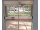 Enclosed sunroom with tile floors and a ceiling fan overlooking the landscaped backyard at 11282 Sw 62Nd Avenue Rd, Ocala, FL 34476