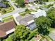 Aerial view of the home featuring a screened pool, lush landscaping, and neighborhood streets at 1172 Trotwood Blvd, Winter Springs, FL 32708