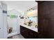 Bright bathroom with double vanity sinks and a modern white tiled walk-in shower at 1172 Trotwood Blvd, Winter Springs, FL 32708
