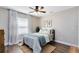 Comfortable bedroom with wood-look floors, ceiling fan, sheer curtains, and bright natural light at 1172 Trotwood Blvd, Winter Springs, FL 32708