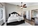 Relaxing bedroom features a ceiling fan, a king-size bed, and ensuite bath at 1172 Trotwood Blvd, Winter Springs, FL 32708