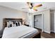 Bedroom with wood-look floors, ceiling fan, natural light, and a walk-in closet at 1172 Trotwood Blvd, Winter Springs, FL 32708