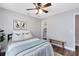 Bedroom with wood-look floors, neutral paint, ceiling fan, and walk-in closet at 1172 Trotwood Blvd, Winter Springs, FL 32708
