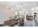 Dining room with modern chandelier opens to the kitchen and breakfast bar at 1172 Trotwood Blvd, Winter Springs, FL 32708
