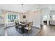 Open-concept dining room with a large window, chandelier, and view of the living area at 1172 Trotwood Blvd, Winter Springs, FL 32708