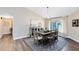 Bright dining room with a wooden table, area rug, and modern chandelier at 1172 Trotwood Blvd, Winter Springs, FL 32708