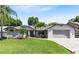 Charming single-story home with a well-manicured lawn, lovely landscaping, and a two-car garage at 1172 Trotwood Blvd, Winter Springs, FL 32708