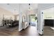 Bright foyer featuring wood floors, an open layout, and views of the dining room at 1172 Trotwood Blvd, Winter Springs, FL 32708