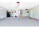 Spacious garage featuring durable epoxy flooring, water heater, and ample storage shelves at 1172 Trotwood Blvd, Winter Springs, FL 32708