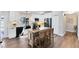 Updated kitchen featuring granite countertops, black appliances, and a central island with bar stools at 1172 Trotwood Blvd, Winter Springs, FL 32708