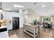 Bright kitchen featuring a black refrigerator, a kitchen island with seating, and a view to the dining room at 1172 Trotwood Blvd, Winter Springs, FL 32708