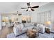 Bright and inviting living room with comfortable seating, ceiling fans, and stylish decor at 1172 Trotwood Blvd, Winter Springs, FL 32708