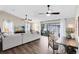 Open living room with wood floors, ceiling fans, and sliding doors to the outdoor space at 1172 Trotwood Blvd, Winter Springs, FL 32708