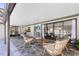 Inviting outdoor patio with wicker furniture, TV, and access to the pool and backyard at 1172 Trotwood Blvd, Winter Springs, FL 32708
