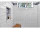 Modern shower with tiled walls, a bench, and a convenient built-in niche at 1172 Trotwood Blvd, Winter Springs, FL 32708