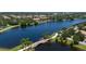 Scenic aerial shot featuring a bridge over a tranquil lake with lush green landscaping at 12185 Obelia Ln, Orlando, FL 32827