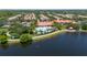Picturesque aerial of a resort-style community with a pool, clubhouse, and serene lake views at 12185 Obelia Ln, Orlando, FL 32827