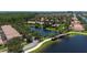 Aerial view of a residential community with a scenic lake, lush landscaping, and well-maintained homes at 12185 Obelia Ln, Orlando, FL 32827