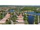 Aerial view of waterfront home with private pool in a lush residential community at 12185 Obelia Ln, Orlando, FL 32827