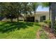 Well-manicured backyard with lush green grass and a screened-in lanai, perfect for outdoor relaxation at 12185 Obelia Ln, Orlando, FL 32827