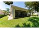Well-maintained backyard featuring a screened-in patio and lush lawn at 12185 Obelia Ln, Orlando, FL 32827