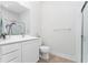 Clean bathroom features a vanity with a sink, toilet, and a glass-enclosed shower at 12185 Obelia Ln, Orlando, FL 32827