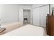 Cozy bedroom featuring twin beds, closet doors, and a connecting hall table with lamp at 12185 Obelia Ln, Orlando, FL 32827