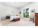 Bedroom with a large window and glass door providing ample natural light and a view of the backyard at 12185 Obelia Ln, Orlando, FL 32827