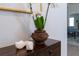 Beautiful decor with orchids on a wooden stand next to white clogs at 12185 Obelia Ln, Orlando, FL 32827
