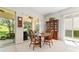 Inviting dining area with natural light from large windows and a classic wooden dining set at 12185 Obelia Ln, Orlando, FL 32827