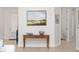 Hallway with side table, painting, and view to an adjacent room at 12185 Obelia Ln, Orlando, FL 32827