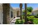 Inviting front entrance with arched doorway, beautiful landscaping, and a brick walkway at 12185 Obelia Ln, Orlando, FL 32827