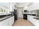 Bright kitchen features white cabinets, stainless steel appliances, and dark granite countertops at 12185 Obelia Ln, Orlando, FL 32827