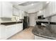 Well-equipped kitchen featuring granite countertops and stainless steel appliances and white cabinets at 12185 Obelia Ln, Orlando, FL 32827
