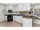 Bright kitchen featuring granite countertops, stainless steel appliances, and convenient breakfast bar seating at 12185 Obelia Ln, Orlando, FL 32827