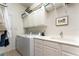 Bright laundry room with washer, dryer, built-in cabinets, and a convenient utility sink at 12185 Obelia Ln, Orlando, FL 32827