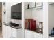Built-in shelving with a large television screen, granite counters and white cabinets for storage at 12185 Obelia Ln, Orlando, FL 32827