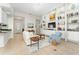 Open concept living room featuring tile floors, plush seating, and custom built-in shelving at 12185 Obelia Ln, Orlando, FL 32827