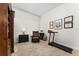 Well-lit office space with a leather chair, treadmill, and decor certificates at 12185 Obelia Ln, Orlando, FL 32827