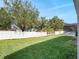 Large backyard featuring manicured lawn and mature trees and a white vinyl fence at 13156 Hatherton Cir, Orlando, FL 32832