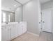 Large bathroom with double sink vanity, tile floors, and walk-in shower with glass door at 13156 Hatherton Cir, Orlando, FL 32832