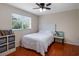 Comfortable bedroom featuring a ceiling fan, wood floors, and bright window at 13156 Hatherton Cir, Orlando, FL 32832