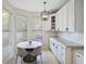 Bright breakfast nook with modern light fixture, neutral color palette, and natural light from the windows at 13156 Hatherton Cir, Orlando, FL 32832