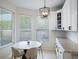 Bright breakfast nook with modern light fixture, neutral color palette, and natural light from the windows at 13156 Hatherton Cir, Orlando, FL 32832